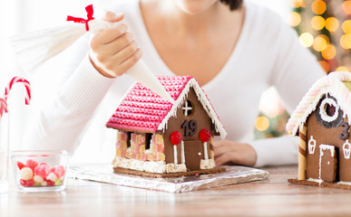 close up of woman making gingerbread houses