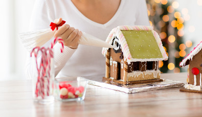 close up of woman making gingerbread houses