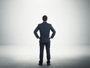 Obraz premium businessman in the suit over grey