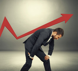 businessman supporting red pointer