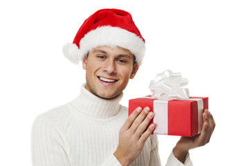 Happy boy with santa hat holding a gift