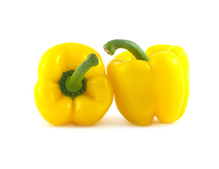 Two ripe yellow ripe bell peppers isolated on white closeup