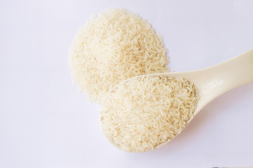 Rice and spoon in isolate on white.