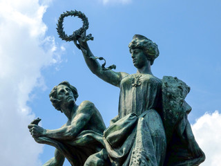 Fototapeta na wymiar Classic bronze statue closeup with blue sky background