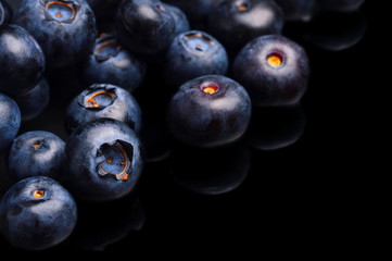 Several whole blueberries isolated on black corner