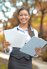 businesswoman standing holding company documents
