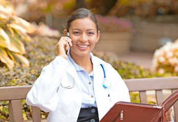smiling female doctor healthcare professional talking on phone