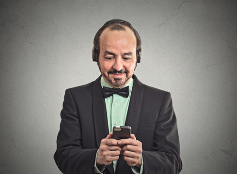 man listening music on smartphone with pair of headphones