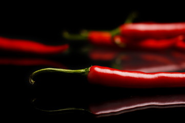 Studio shot of chilli peppers on black