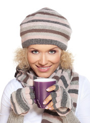 Woman in winter clothes drinking tea
