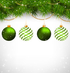 Two green and two spiral Christmas balls on green pine branches