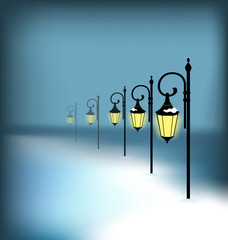 Lanterns stand in snow on blue background