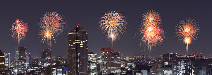 Fototapeta premium Fireworks celebrating over Tokyo cityscape at night, Japan