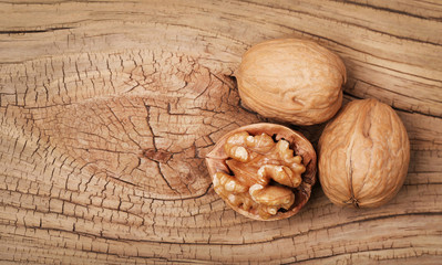 Walnuts on old wooden background