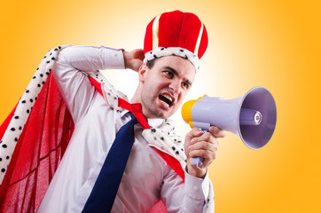 King businessman with loudspeaker isolated on white