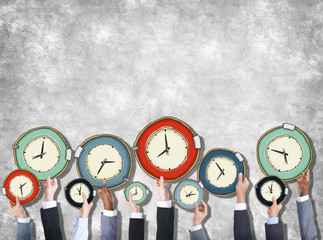 Group of Hands Holding Clock