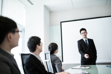 businessman giving a presentation to his colleagues
