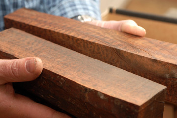 Hands with square blocks of wood
