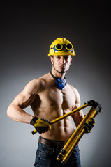 Fototapeta premium Ripped muscular builder man with tools