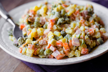 Russian traditional salad olivier with pea, new year