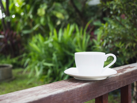 Cup of coffee in garden wooden terrace