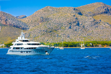 Ship against mountains of Port de Pollenca, Mallorca