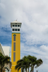 Old Yellow Tower by Palm Trees in Nassau