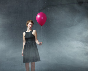 girl with party dress and helium balloon on hand