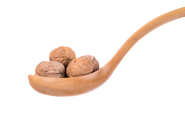 Wooden spoon full with walnuts