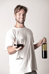 Young man relaxing with a bottle of red win