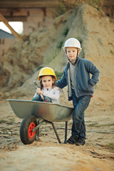boy and girl playing on construction site
