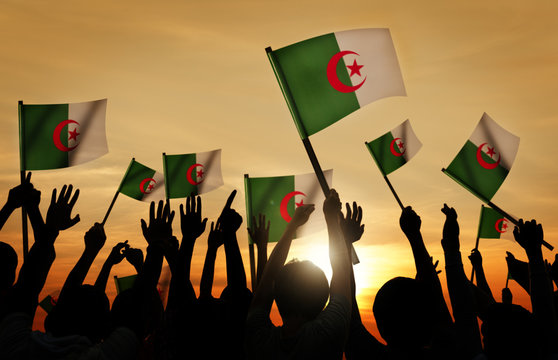 Silhouettes of People Holding Flag of Algeria