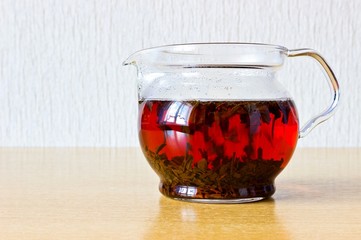 Strong black ceylon tea in glass teapot - obrazy, fototapety, plakaty