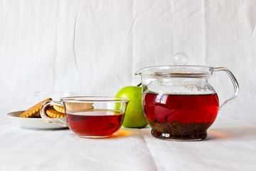Strong black ceylon tea with cookies and fresh ripe apple