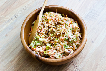 Fresh vegetable salad in wooden bowl with wooden spoon