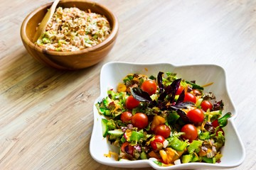Fresh salads in ceramic and wooden bowl. Selective focus