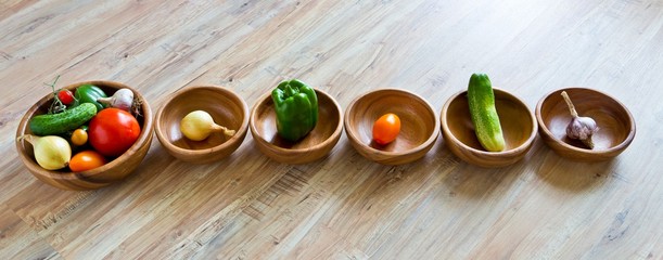 Fresh vegetables in wooden bowls row. Panoramic image