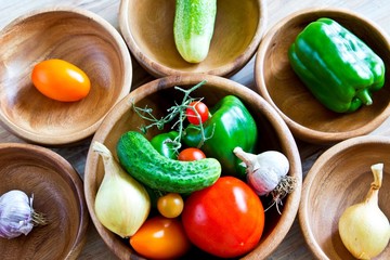Fresh vegetables in wooden bowls