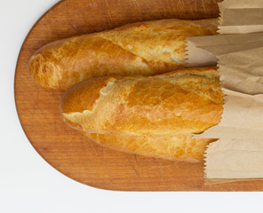 Baguettes packaged in a paper on a board