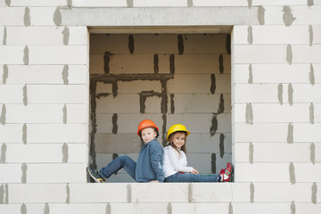 boy and girl playing on construction site