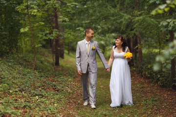 bride and groom wedding walk in park in summer