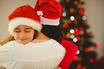 Fototapeta na wymiar Mother and daughter hugging at christmas