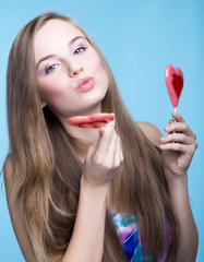 beautiful model with lollipops in the shape of a heart