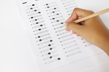 Standardized test form with answers bubbled in and a pencil, foc