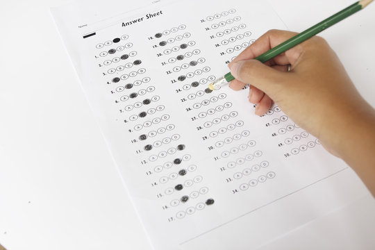 Standardized test form with answers bubbled in and a pencil, foc