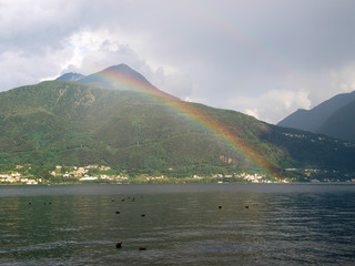 Landscape with rainbow in the evening light.