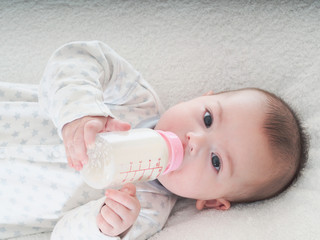 Baby boy  drinking milk from the bottle at home © basnik_bna