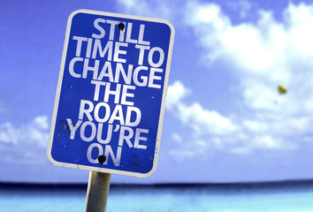 Still Time To Change the Road You're On sign with a beach
