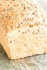 Loaf of bread on wooden table close up