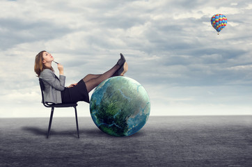 businesswoman dreaming sitting on a chair in the open air.